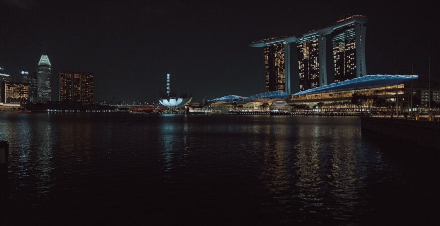 Captivating night view of Singapore skyline featuring Marina Bay Sands and cityscape reflections.